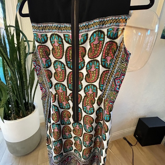 Above the knee dress, skirt has a faux wrap opening, zipper closure in back. - Picture 3 of 4